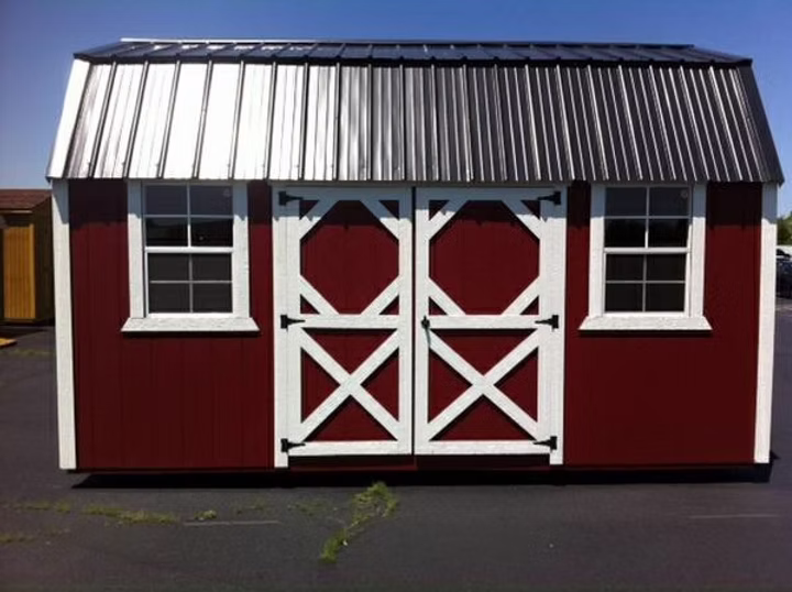 Backyard Side Lofted Barn - painted in classic style Barn Red w/ white trim and a black metal roof.